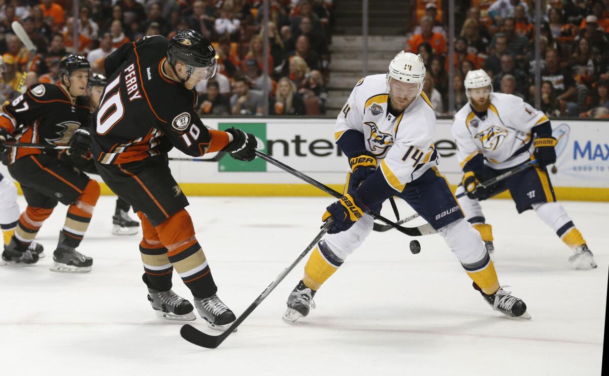 Ducks right wing Corey Perry (10) passes the puck between the legs of Predators right wing Craig Smith during a first-round playoff game at Honda Center on April 17.