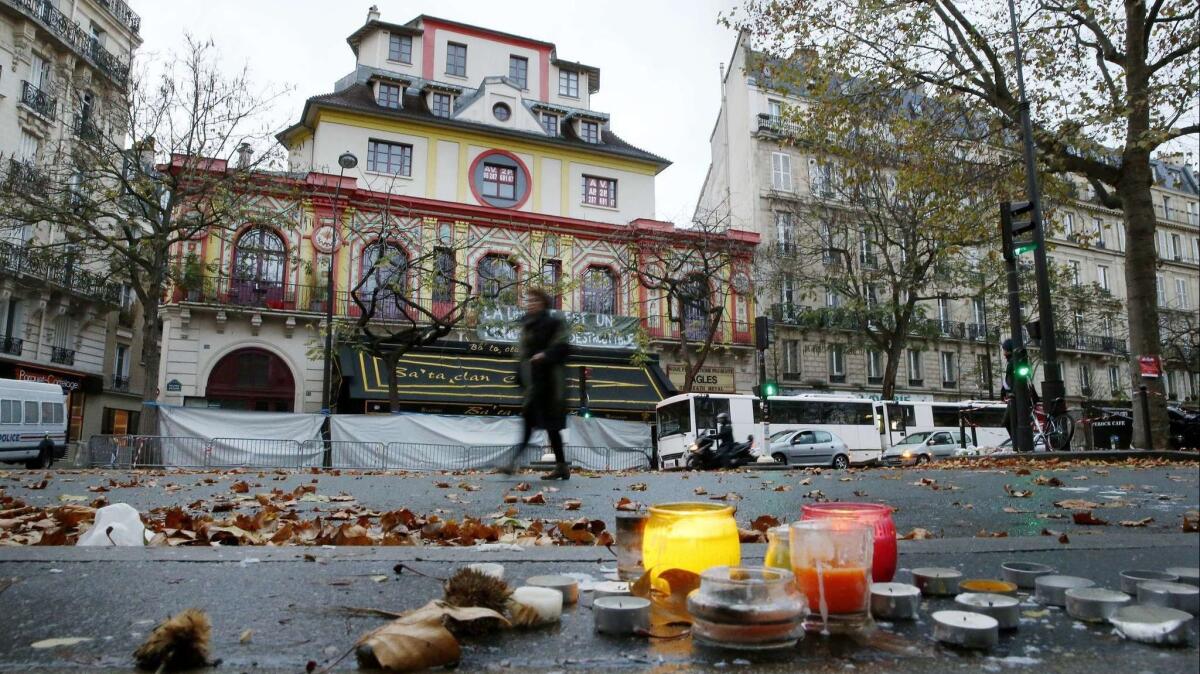 A woman walks past the Bataclan concert hall in Paris, the site of a deadly terror attack in November 2015.