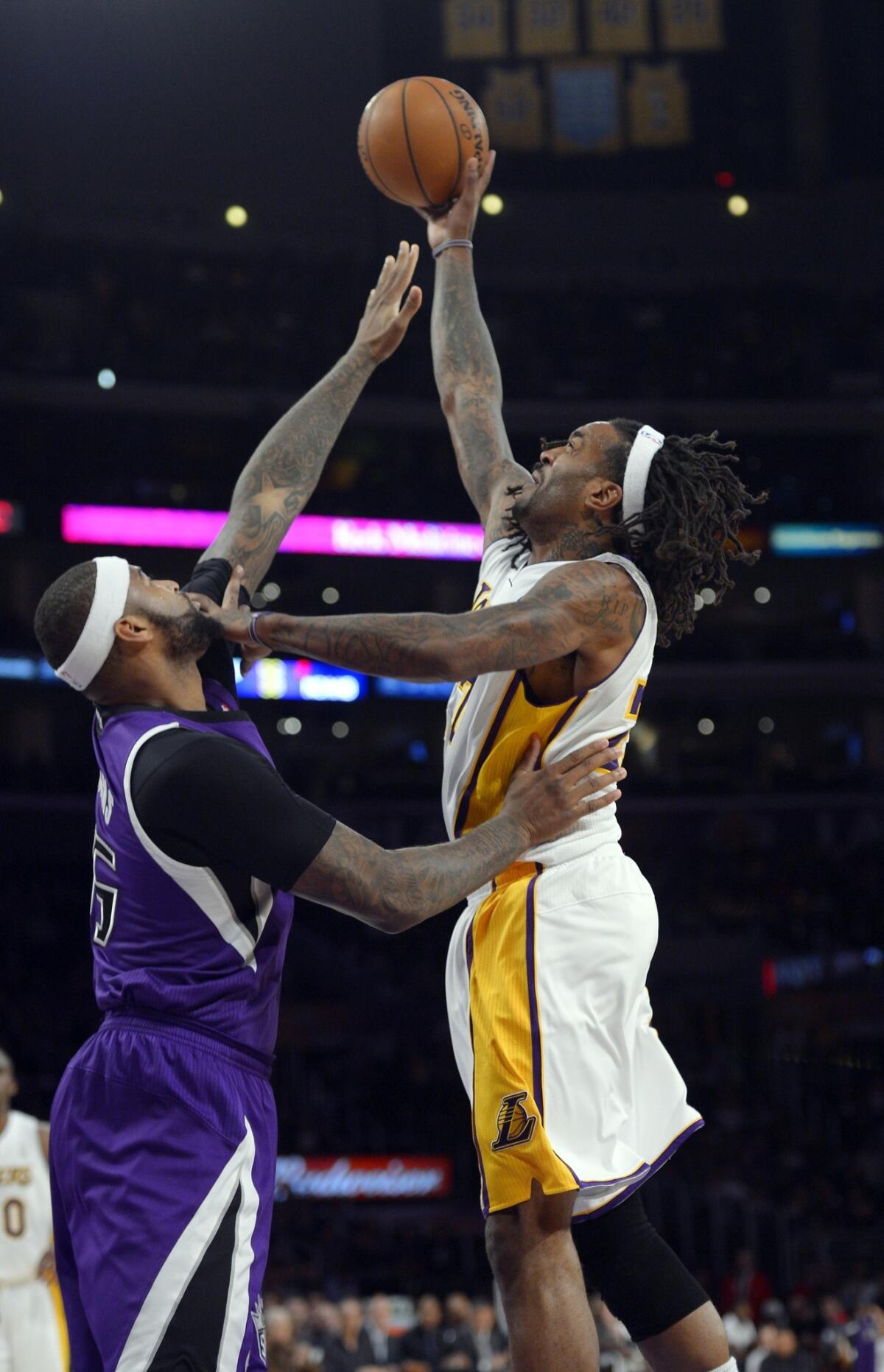 Lakers power forward Jordan Hill elevates for a shot over Kings center DeMarcus Cousins.