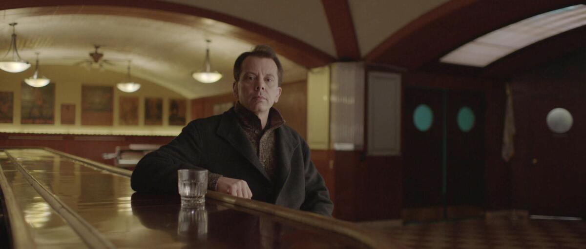 Gerald Blanchard sitting a bar with a glass in front of him.