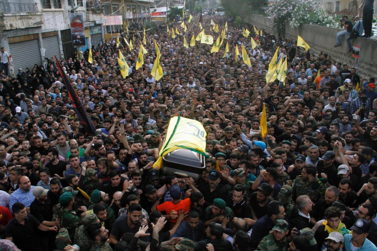 The coffin of Hezbollah leader Mustafa Badreddine is carried through the streets of Beirut in May.