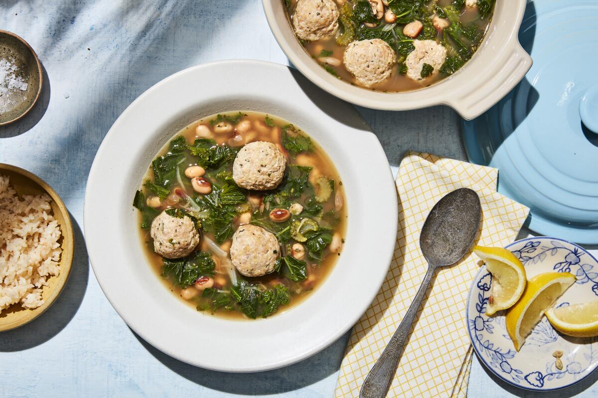 Overhead view of bowls of soup with several hearty meatballs.