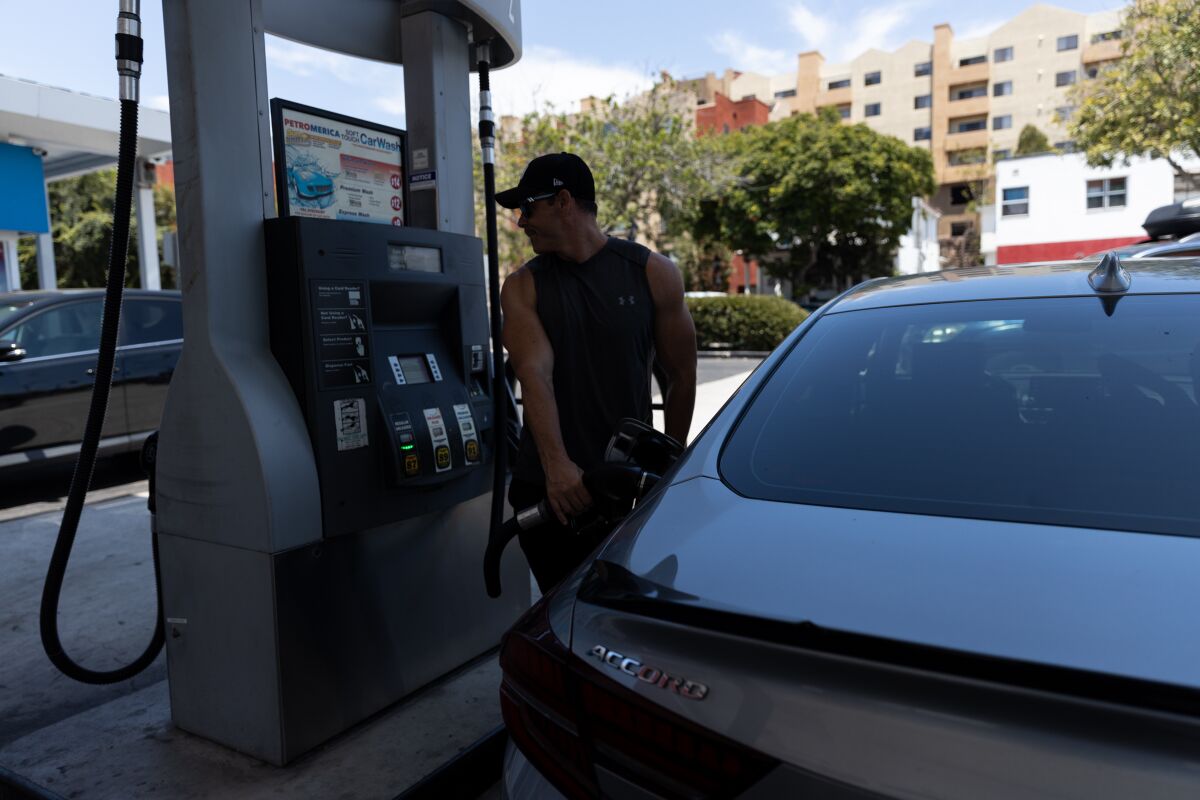 Brandon Gautreaux fills up his Honda Accord at Petromerica in downtown San Diego on Thursday, July 14, 2022.