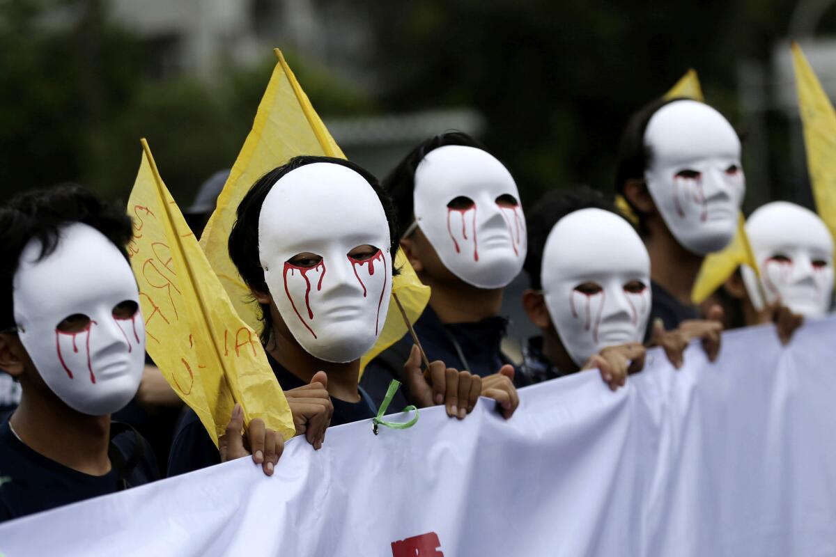 Workers wear masks during a May Day rally in Jakarta, Indonesia. (Achmad Ibrahim / Associated Press)