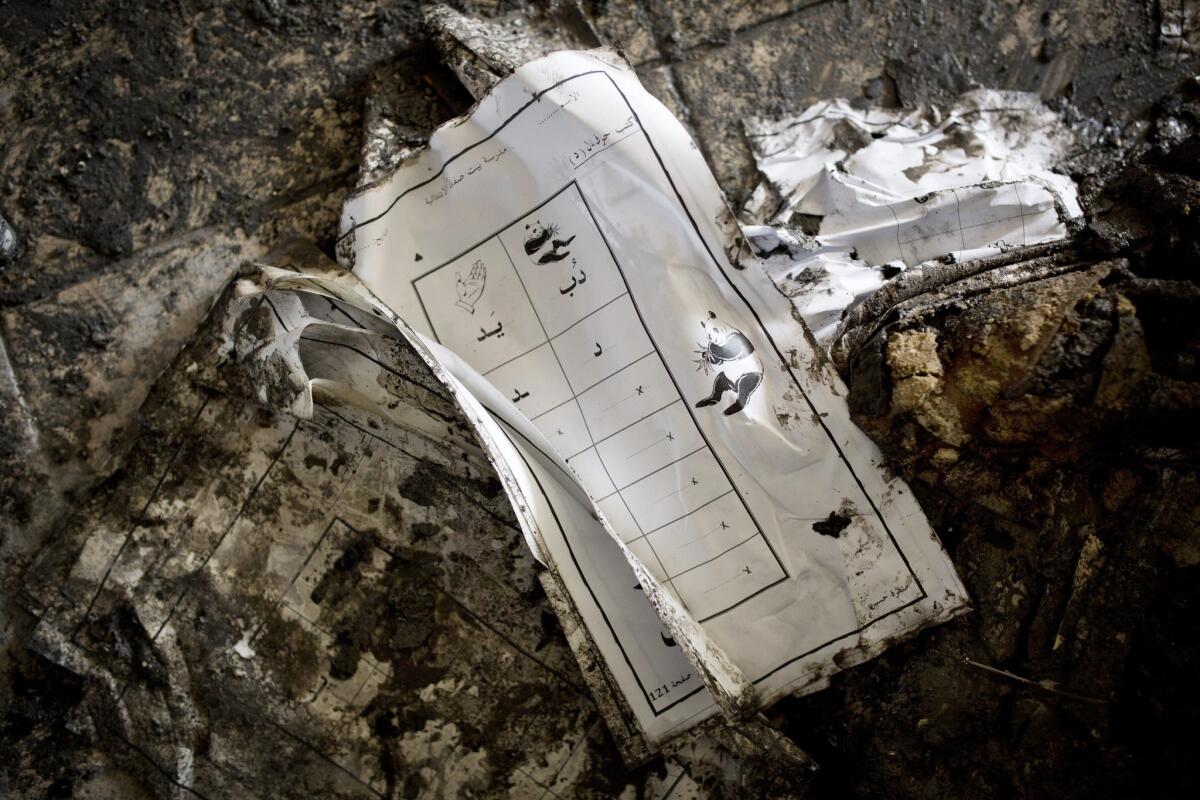 A partially burned schoolbook amid the ashes in a burned out classroom of a Hebrew-Arabic school called Hand in Hand in Jerusalem on Nov. 30.