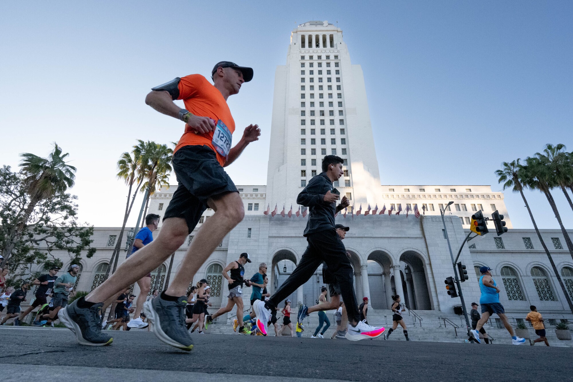 Runners head past City Hall during the 2022 Los Angeles Marathon.