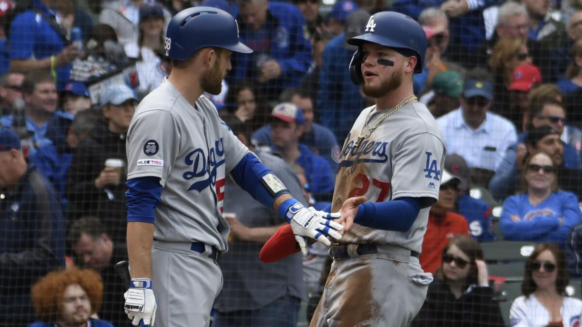 Dodgers' Alex Verdugo (27) is greeted by Rocky Gale (58) after scoring against the Chicago Cubs during the fifth inning on Thursday in Chicago.