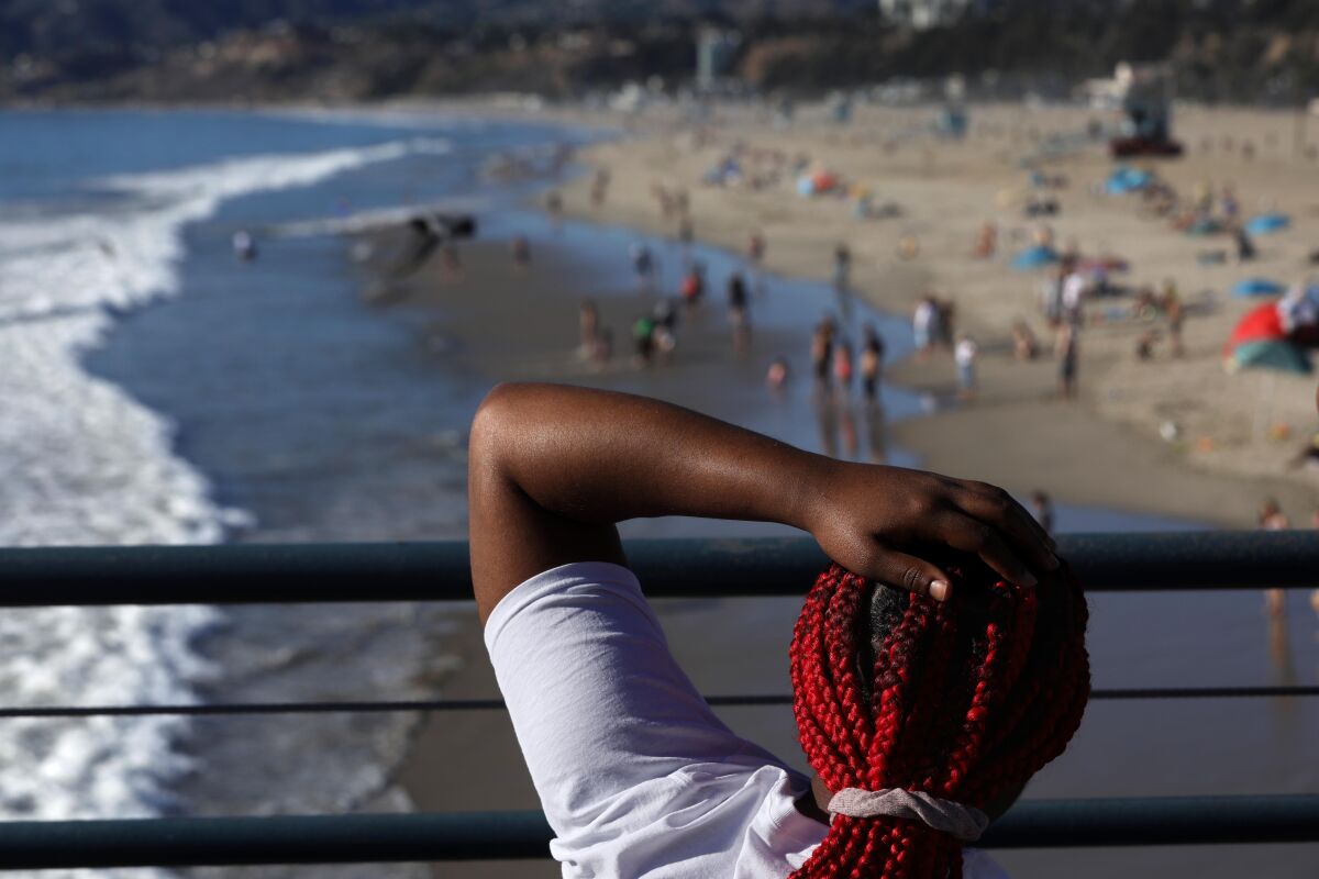 Jade Smith, 18, of Memphis, Tenn., looks down on the beach at Santa Monica