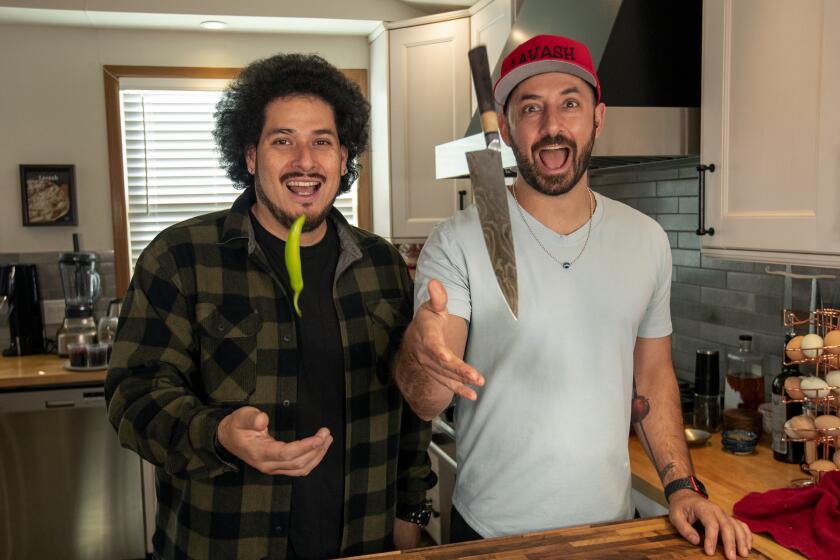 CHATSWORTH, CA-FEBRUARY 12, 2023:Mexican/Armenian comedian Jack Assadourian, stage name Jack Jr., left, and Armenian chef Ara Zada, pose together at Zada's home in Chatsworth. They created a monthly pop up restaurant featuring the food they make for their viral videos at Haha Comedy Club in North Hollywood. (Mel Melcon / Los Angeles Times)