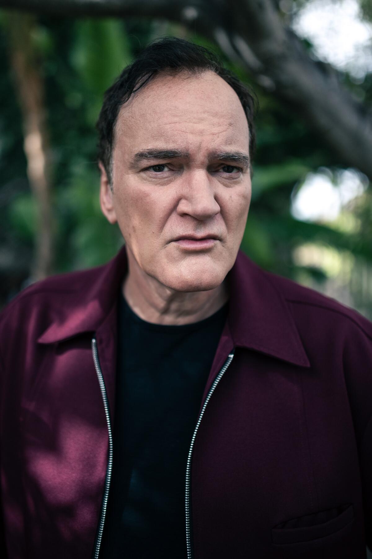 Quentin Tarantino in a dark purple jacket