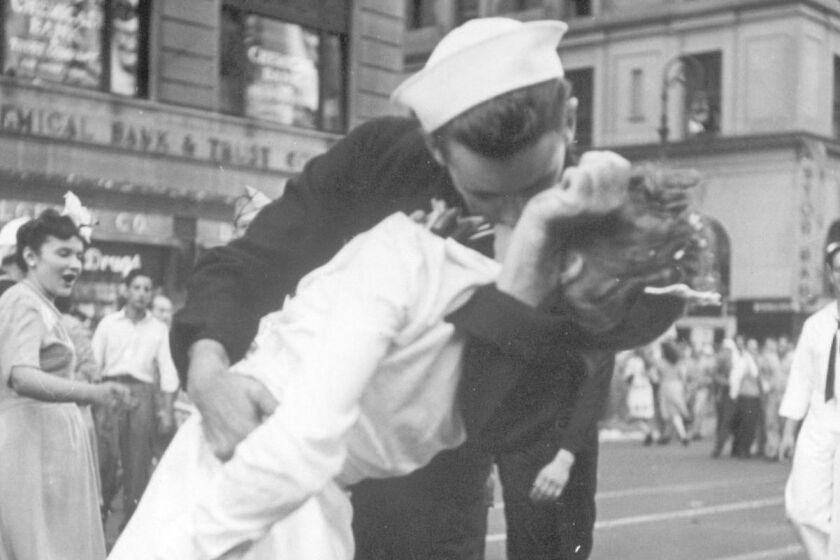 FILE - In this Aug. 14, 1945 file photo provided by the U.S. Navy, a sailor and a woman kiss in New York's Times Square, as people celebrate the end of World War II. The ecstatic sailor shown kissing a woman in Times Square celebrating the end of World War II has died. George Mendonsa was 95. It was years after the photo was taken that Mendonsa and Greta Zimmer Friedman, a dental assistant in a nurseâs uniform, were confirmed to be the couple. (Victor Jorgensen/U.S. Navy, File)
