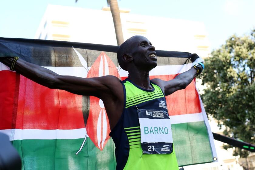 LOS ANGELES, CA-MARCH 24, 2019: Runner Elisha Barno celebrates finishing in first place during during the Los Angeles Marathon on March 24, 2019, in Los Angeles, California. (Photo By Dania Maxwell / Los Angeles Times)