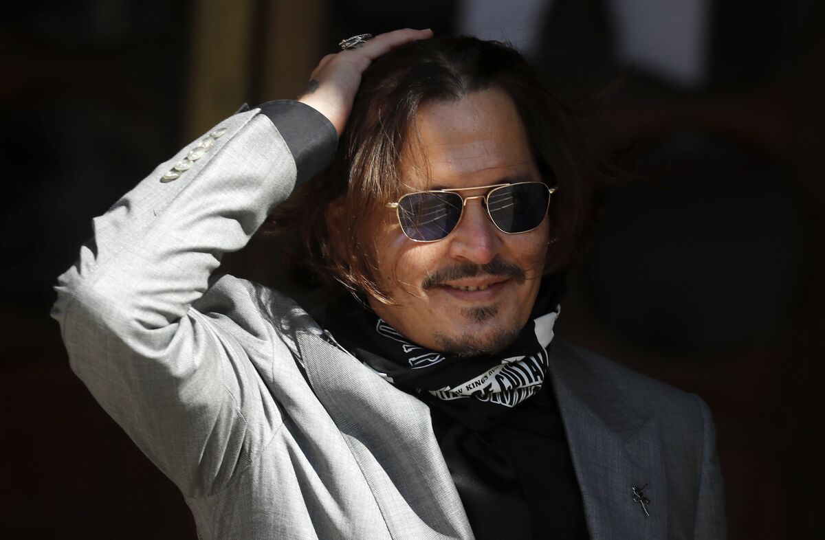 FILE - In this file photo dated Tuesday, July 28, 2020, US Actor Johnny Depp arrives at the High Court in London during his case against News Group Newspapers over a story published about his former wife Amber Heard, which branded him a 'wife beater'. A British judge is set to deliver his judgement in writing on Monday Nov. 2, 2020, deciding whether a tabloid newspaper defamed Depp by calling him a “wife beater." (AP Photo/Frank Augstein, FILE)