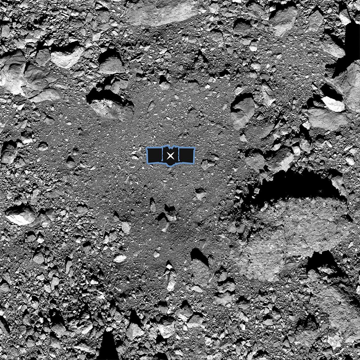 An "X" is superimposed on a spot on the surface of the asteroid.