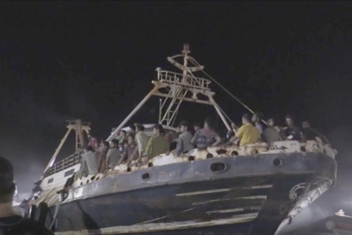 A fishing boat crowded with migrants docked in the Sicilian island of Lampedusa.