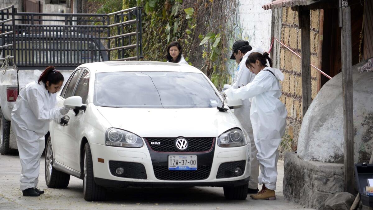Temixco is no stranger to violence. In 2016, forensic investigators inspect a car outside the home where Gisela Mota was killed, one day after taking office as mayor.