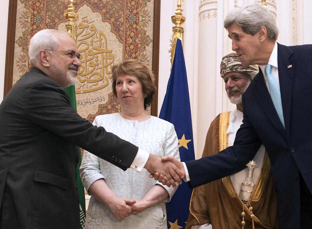 Secretary of State John F. Kerry, right, and Iranian Foreign Minister Javad Zarif shake hands in Muscat, Oman, on Nov. 9. With them are European Union envoy Catherine Ashton and Omani Foreign Minister Youssef ibn Alawi.
