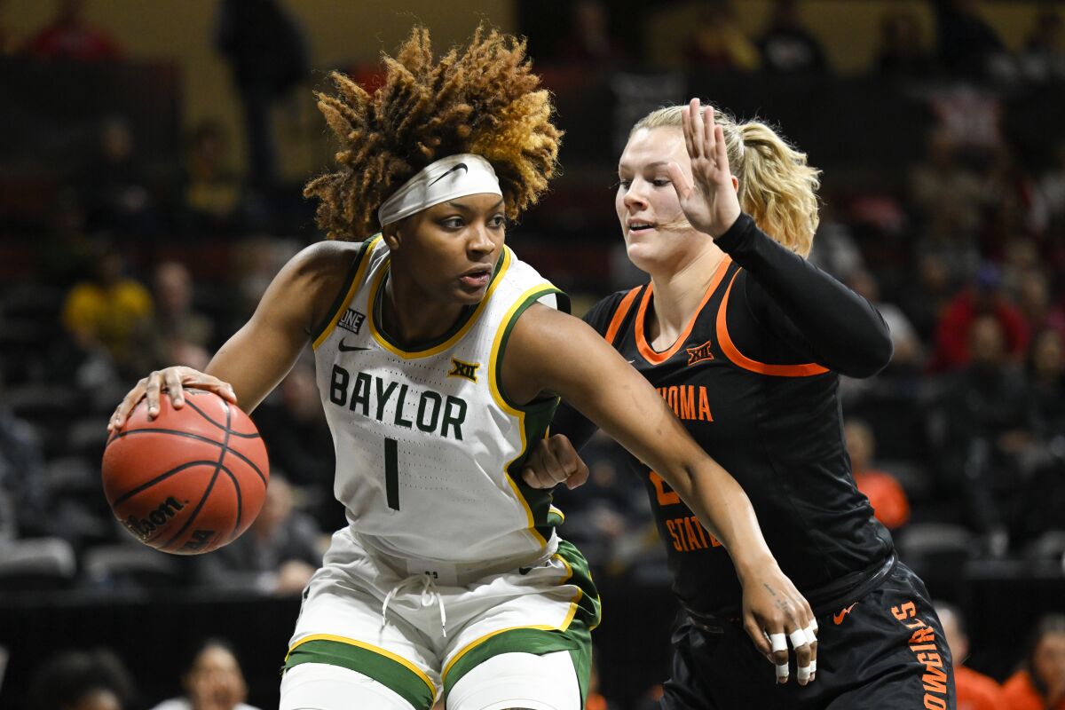 CORRECTS SCHOOL TO OKLAHOMA STATE INSTEAD OF OKLAHOMA - Baylor forward NaLyssa Smith (1) works against Oklahoma State forward Abbie Winchester (25) during the first half of an NCAA college basketball game in the Big 12 Conference tournament in Kansas City, Kan., Friday, March 11, 2022. (AP Photo/Reed Hoffmann)