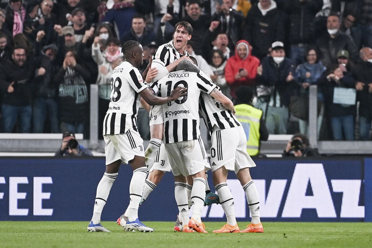 Juventus' Federico Bernardeschi, center obscured, celebrates after scoring during the Italian Cup semifinal soccer match between Juventus and ACF Fiorentina at the Allianz Stadium in Turin, Italy, Wednesday, April 20, 2022. (Marco Alpozzi/LaPresse via AP)