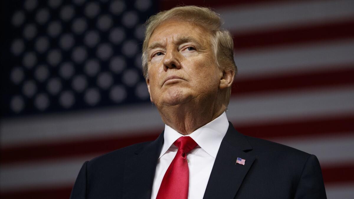 President Trump pauses during remarks at a campaign rally at Florida State Fairgrounds Expo Hall on Tuesday in Tampa, Fla.