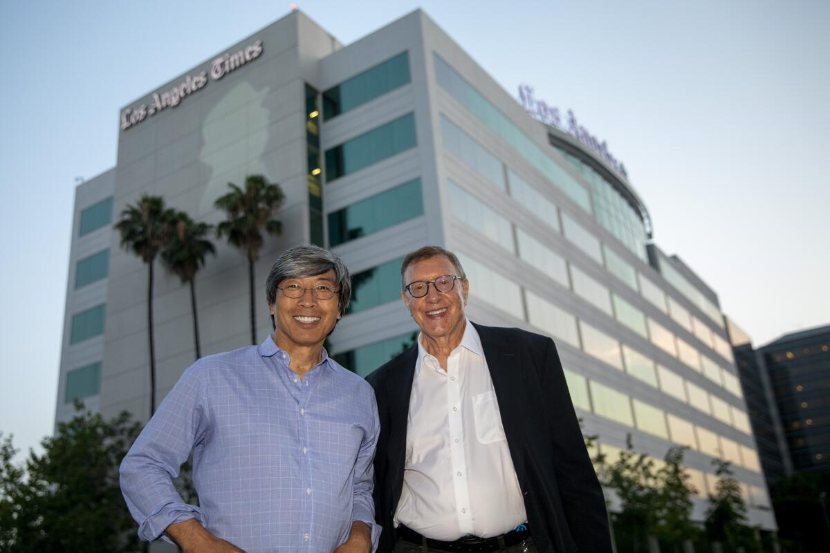 Dr. Patrick Soon-Shiong and Norman Pearlstine stand outside the L.A. Times building in El Segundo in July 2018. 