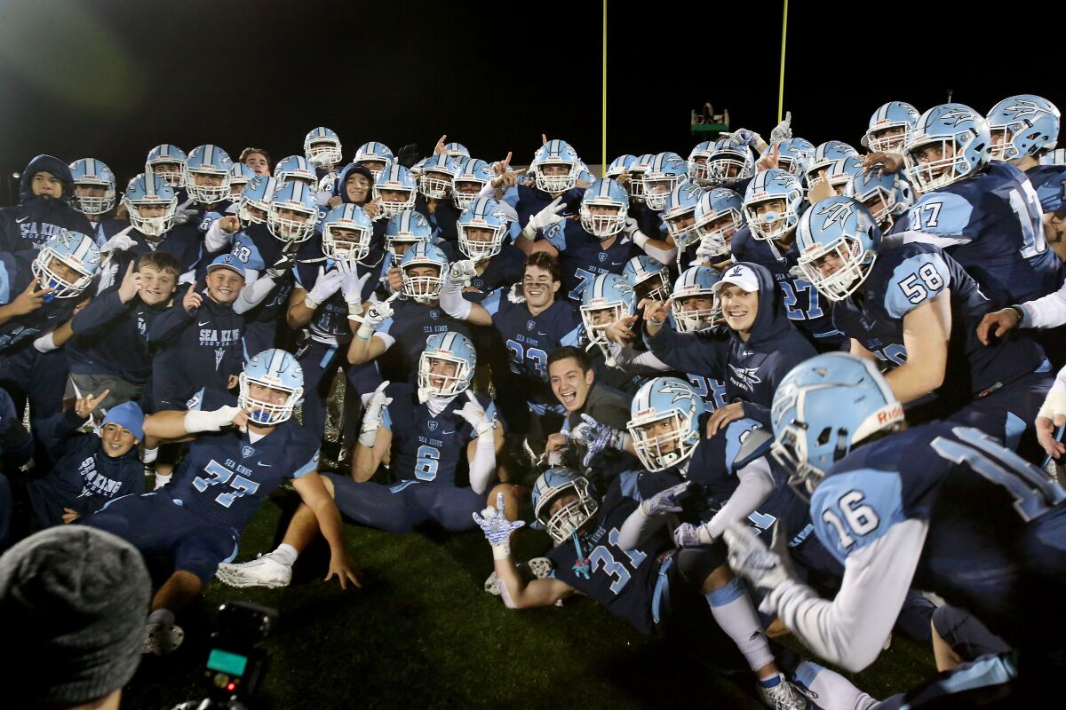Corona del Mar celebrates after defeating Grace Brethren 56-28 in the CIF Southern Section Division 3 title game on Friday at Newport Harbor High.