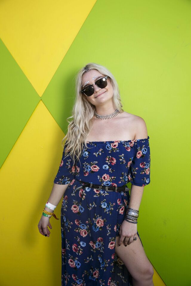 Kylie Warren, 21, of Tucson, proves the off-the-shoulder trend is still thriving in a floral maxi dress and jewel-bedecked eyebrows, as she stands for a portrait during weekend one of the three-day Coachella Valley Music and Arts Festival at the Empire Polo Grounds on Saturday, April 15, 2017 in Indio, Calif. (Patrick T. Fallon/ For The Los Angeles Times)