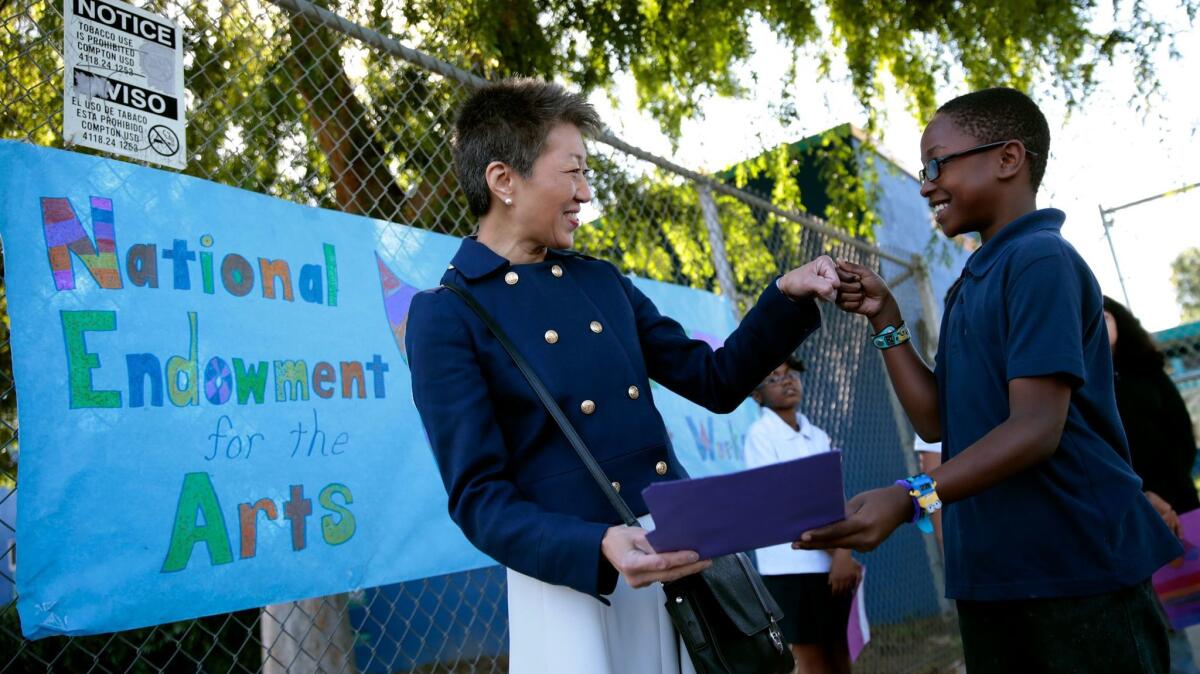 Jane Chu, chairperson of the National Endowment for the Arts, greets 4th-grader Jamiah Walker, 10, at Martin Luther King Jr. Elementary School in Los Angeles in 2015.