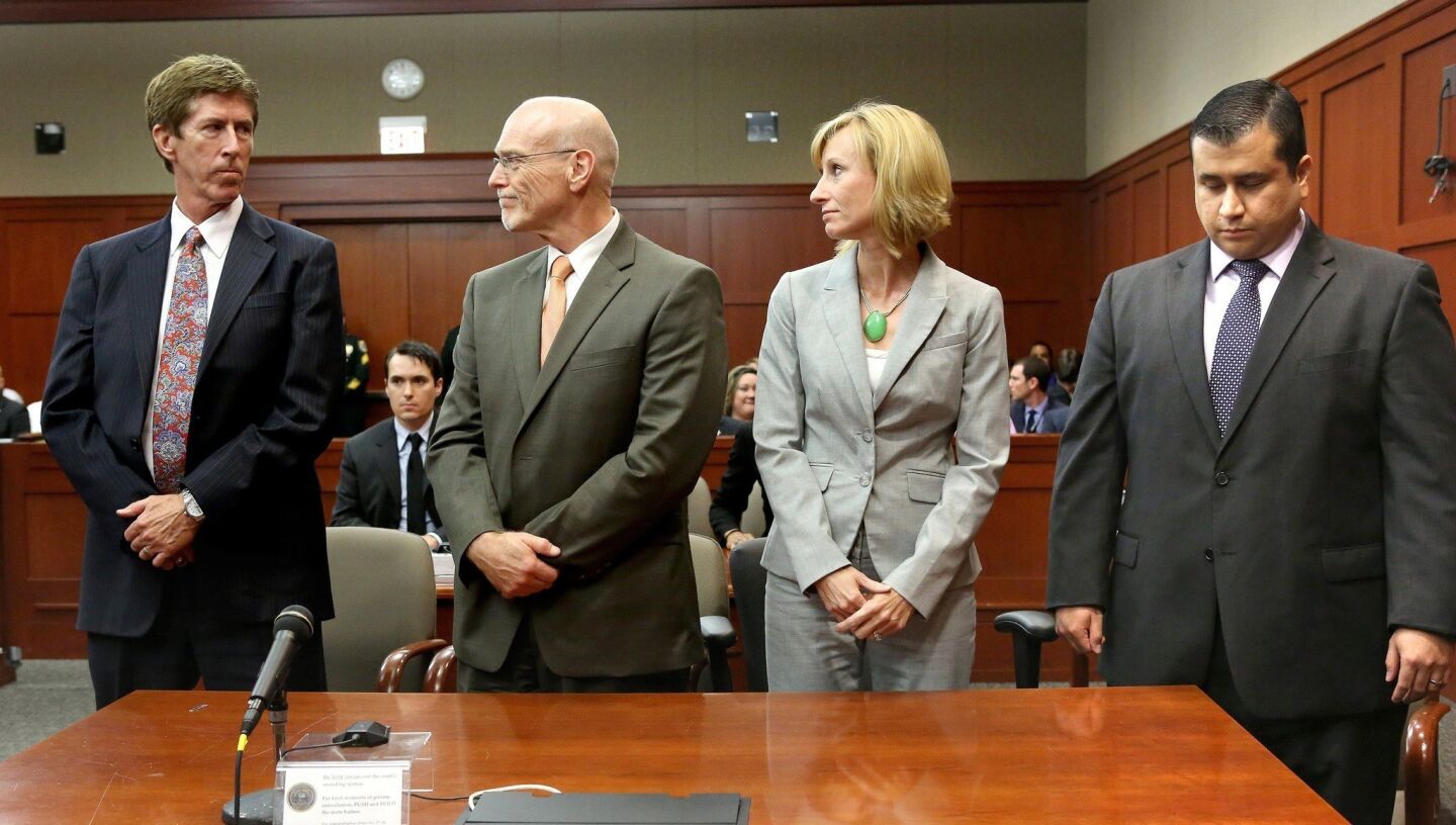 George Zimmerman looks down as the not-guilty verdict is read. From left are attorneys Mark O'Mara, Don West and Lorna Truett.