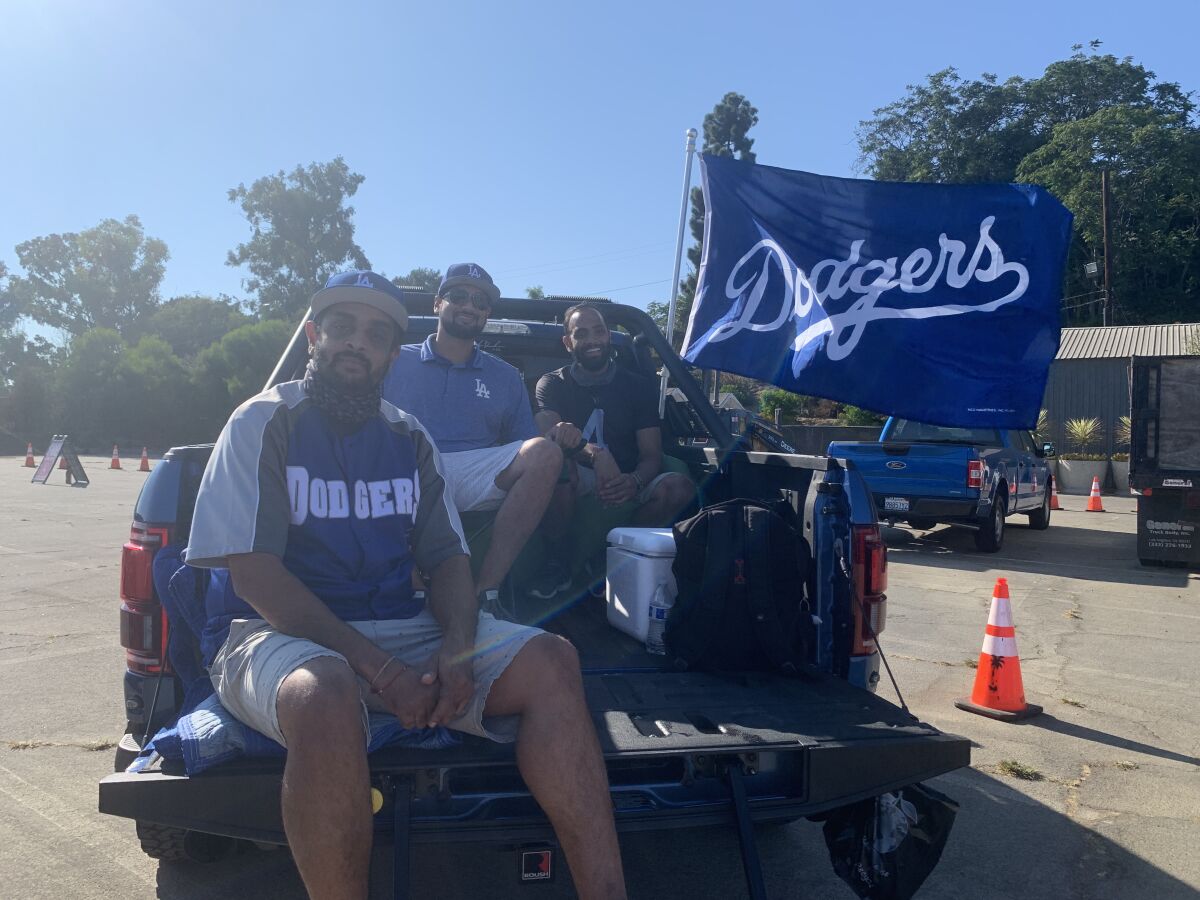Cousins Anish Patel, Rickesh Patel and Vickash Keval set up a lounge chair and bean bag in the bed of Anish’s pickup truck.