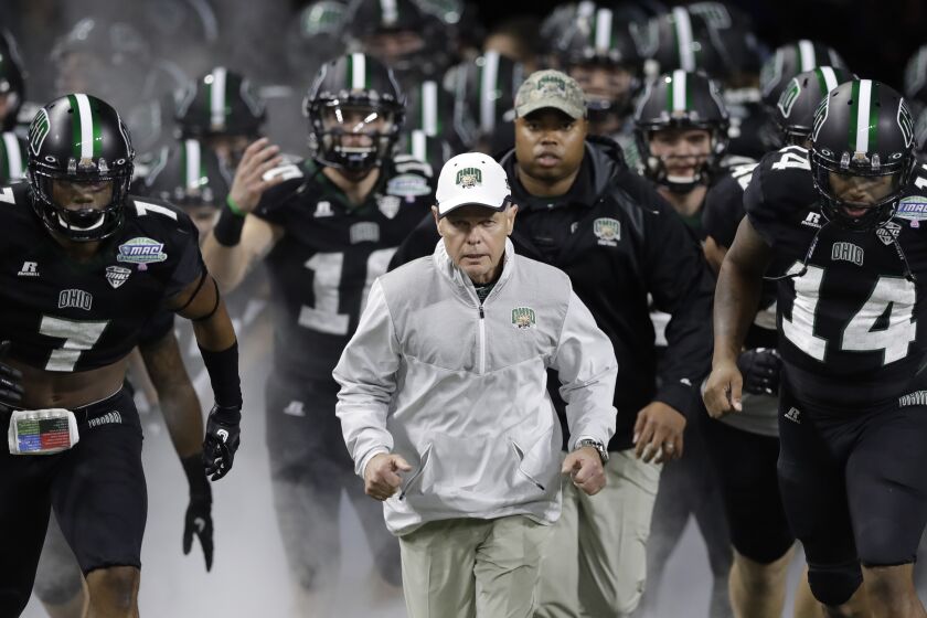FILE - Ohio head coach Frank Solich runs out onto the field with his team before the Mid-American Conference championship NCAA college football game against Western Michigan, in Detroit, Dec. 2, 2016. Former Nebraska coach Frank Solich will make his first public appearance at Memorial Stadium in 20 years when Nebraska honors him at its spring game on April 22, 2023. (AP Photo/Carlos Osorio, File)