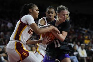 USC's Taylor Bigby and Rayah Marshall try to steal the ball from Washington's Chloe Briggs.