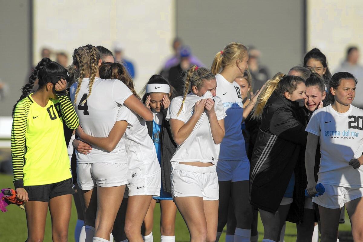 Corona del Mar High players console each other after losing their first game of the season, to La Mirada in the quarterfinals of the CIF Southern Section Division 2 playoffs on Friday.