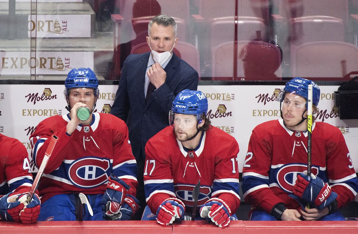 Montreal Canadiens interim coach Martin St. Louis watches from behind the bench during the first period of the team's NHL hockey game against the Washington Capitals on Thursday, Feb. 10, 2022, in Montreal. (Graham Hughes/The Canadian Press via AP)