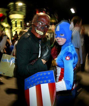 Niraj Patil of Oakland, left, and Elizabeth Wolcot from Marina, Calif., join forces for a photograph together on the convention floor at Comic Con Convention.