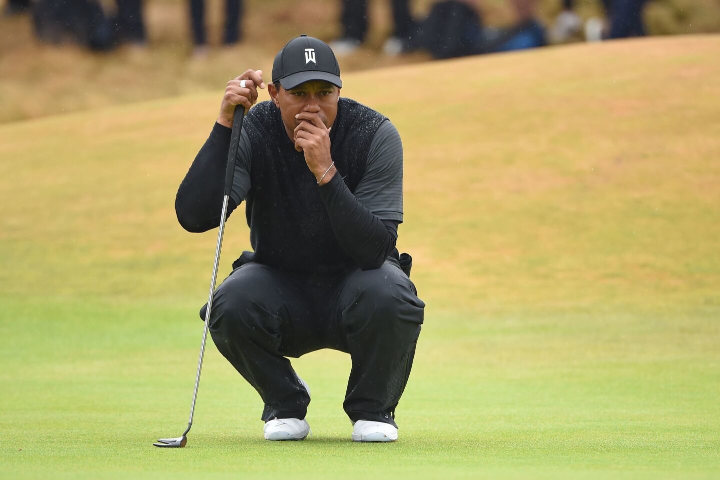 Tiger Woods studies a putt on the ninth green during the second round of the British Open.