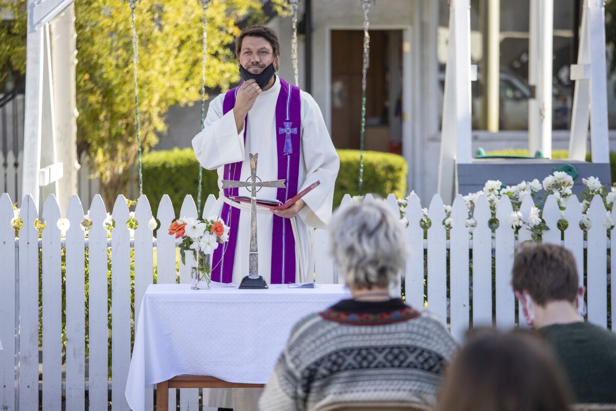 Pastor Morgan Berg leads an outdoor service on St. Lucia's Day at the Norwegian Seamen's Church.  