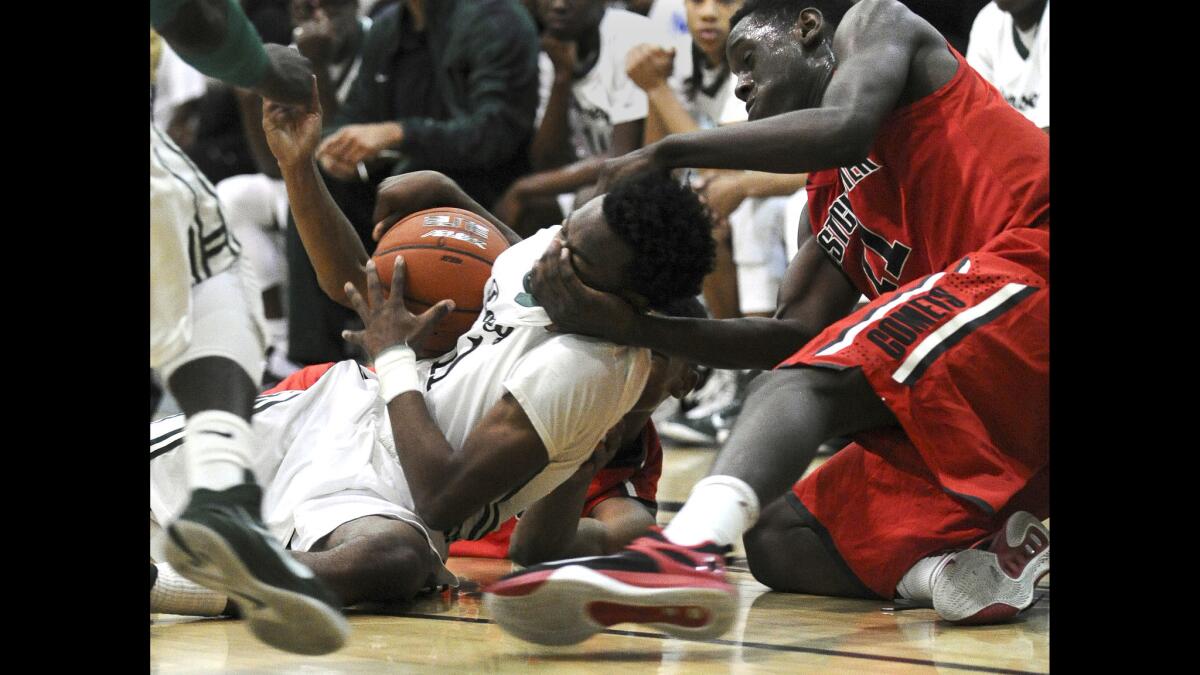 Westchester's L.T. Taylor grabs the face of Dorsey's Albert Allison while battling for a loose ball in the City Open Division semifinal game at Roybal High School on Saturday.