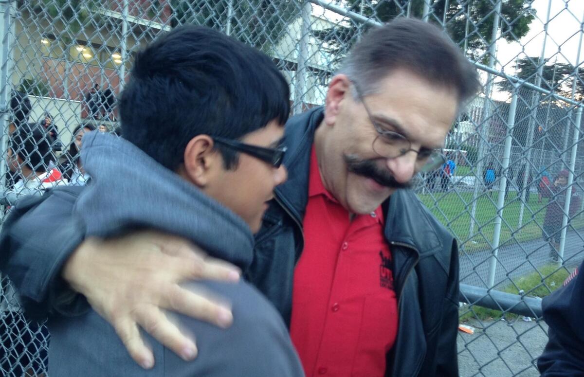 Stuart Lutz, right, a South Gate Middle School art teacher, returned to class Wednesday after being cleared of wrongdoing in a case that drew attention to the LAUSD's "teacher jail" system. Those welcoming him back include former student Armando Chavez, now in high school.