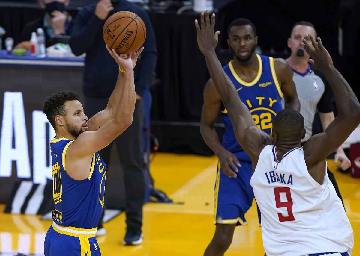 Golden State's Stephen Curry takes a three-point shot over the Clippers's Serge Ibaka on Jan. 8, 2021. 