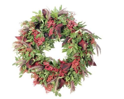 Pink-hued berries, bushy-tipped grasses and emerald-green leaf clusters lend savory style to a California pepper wreath by Walter Hubert of Silver Birches in Pasadena.