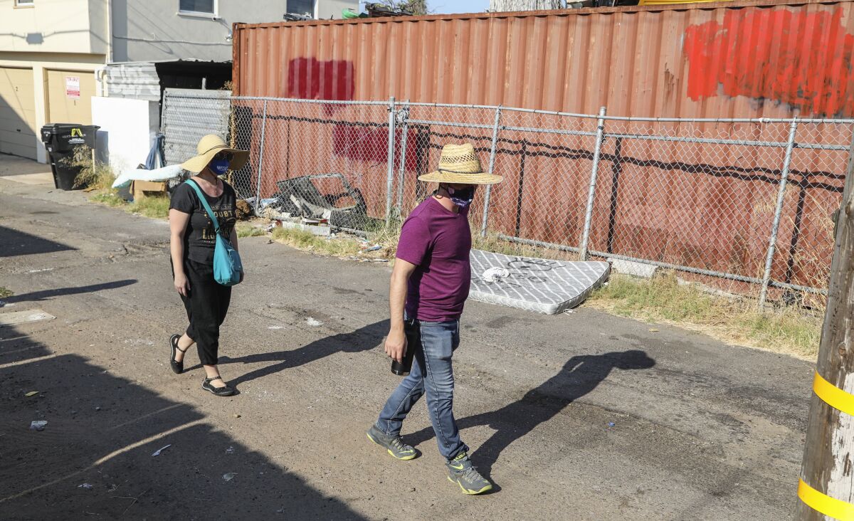 James Lively and Lydia Bringerud report trash in a alley with the Get it Done app. 