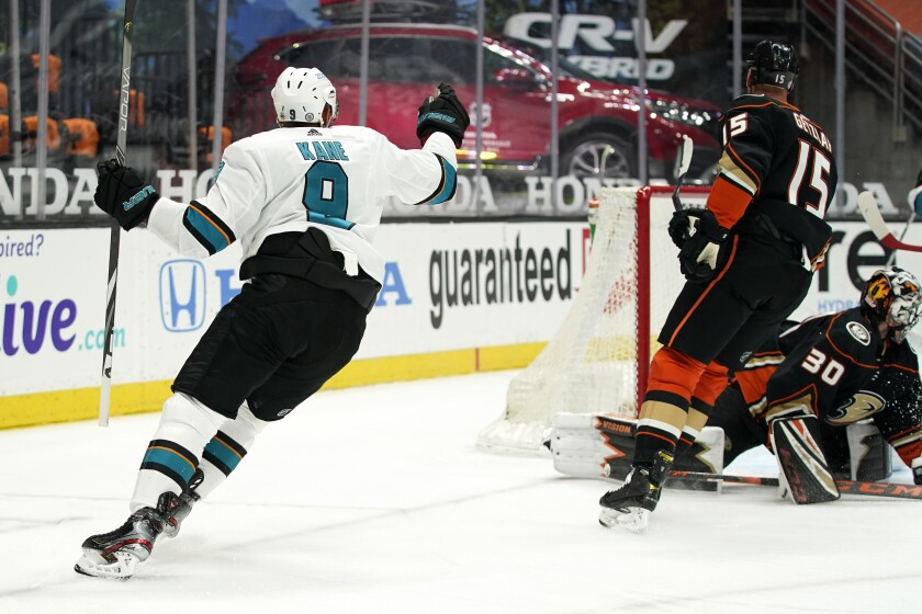 The Sharks' Evander Kane reacts after scoring on the Ducks' Ryan Miller (30) as center Ryan Getzlaf skates past the goalie.