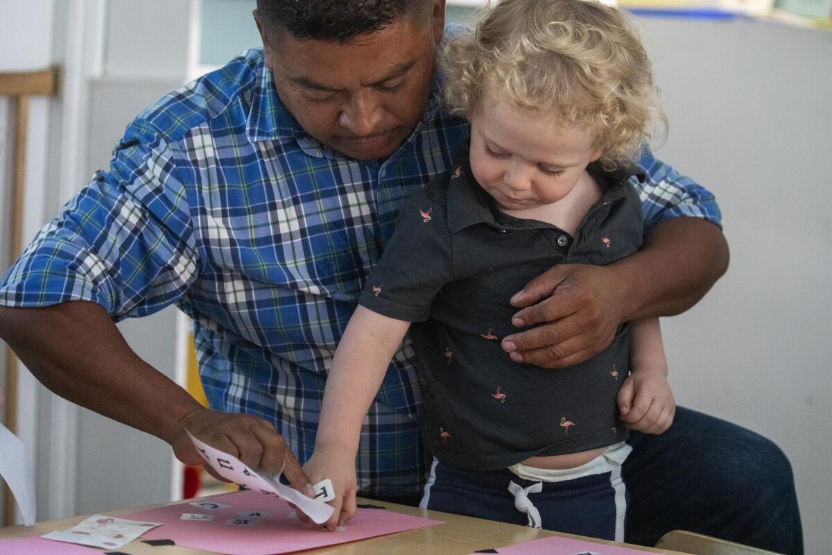 Ricky Gonzalez with a toddler at the Atwater Park Center