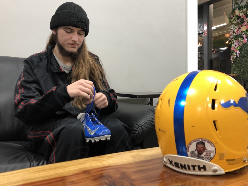 They lost loved ones to police violence. George Floyd's
killing has made the pain new again 4 Gabe Murphy ties the laces on one of his football cleats, and a helmet on the table has a sticker of his late father