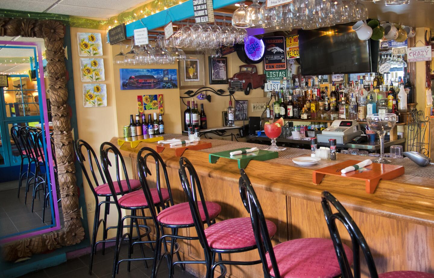 Customers can sit at a bar at Lista's Grill in Pasadena.