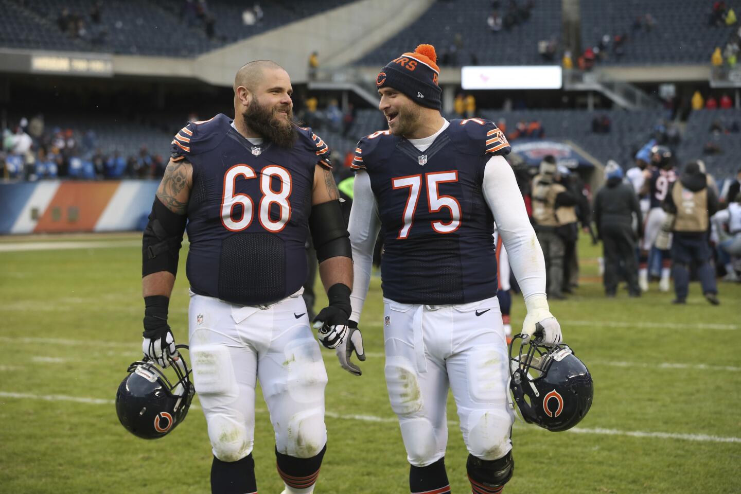 Matt Slauson and Kyle Long walk off the field after the season finale at Soldier Field in 2016.