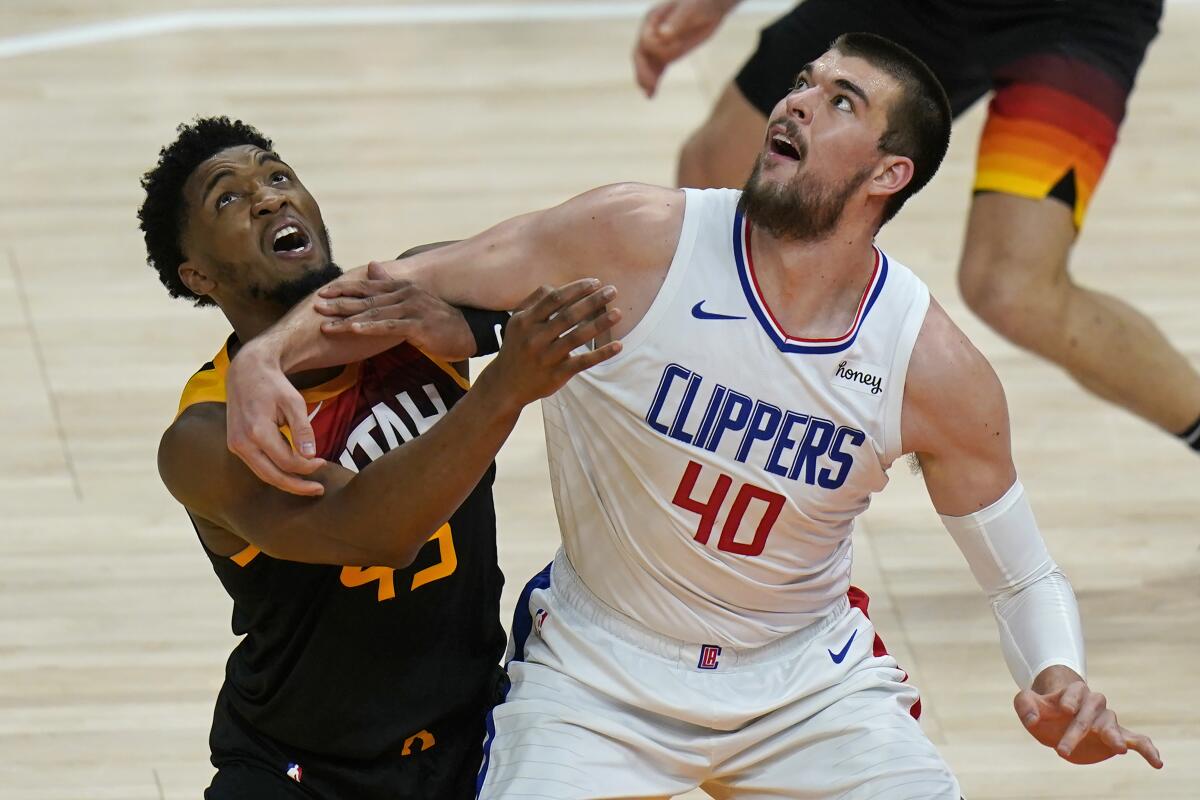 Clippers center Ivica Zubac, right, and Utah Jazz guard Donovan Mitchell battle for position June 10, 2021.