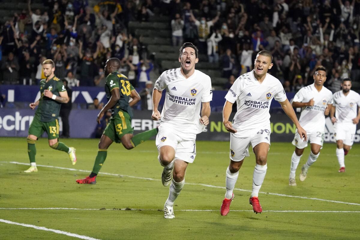 LA Galaxy midfielder Sacha Kljestan, center, celebrates after scoring on a penalty kick.