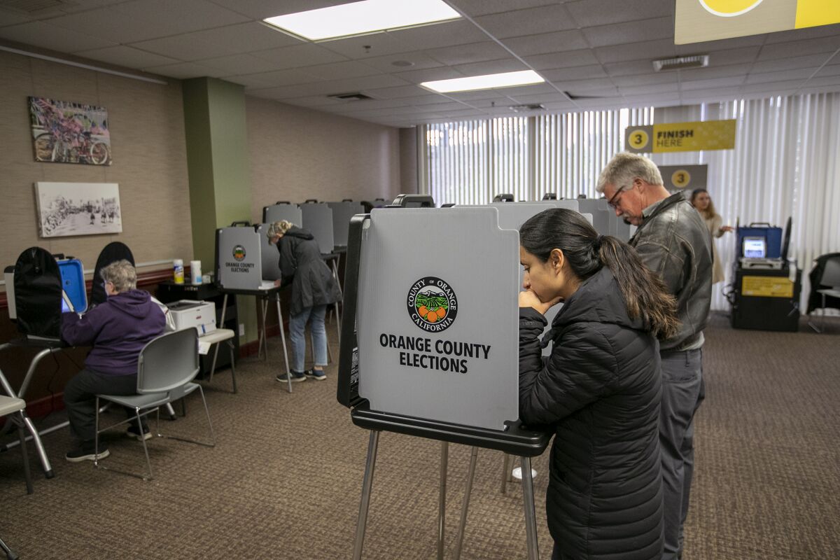 Aimee Banderschelden casts her ballot at the Huntington Beach City Hall on Tuesday.